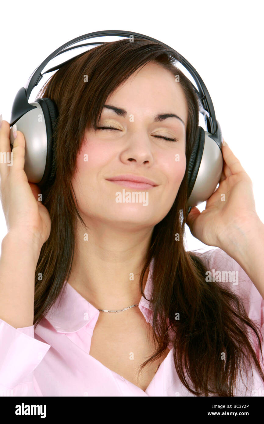 Junge Frau hoert Musik mit Kopfhoerer portrait of a young woman listening to music with headphone Stock Photo