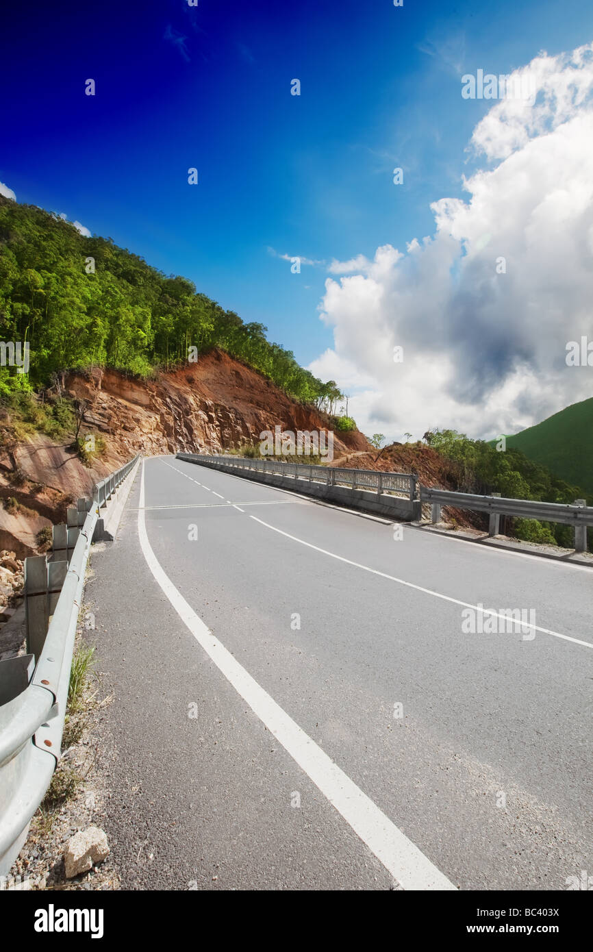Mountain road at sunny day with some clouds on the sea Stock Photo - Alamy