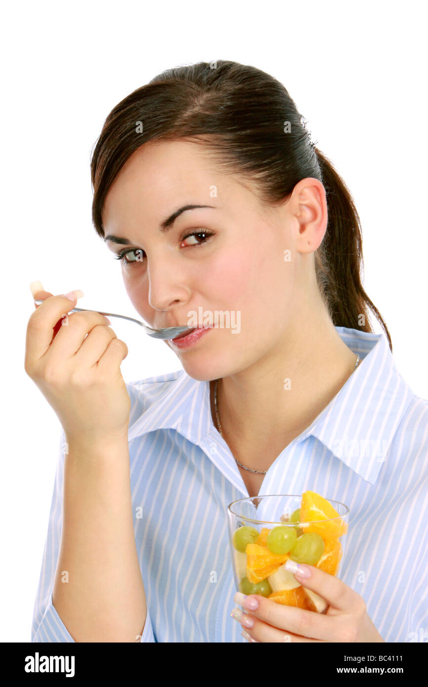 Frau geniesst einen Obstsalat woman enjoys a fruit salad Stock Photo