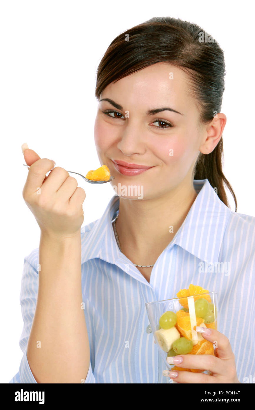 Frau geniesst einen Obstsalat woman enjoys a fruit salad Stock Photo