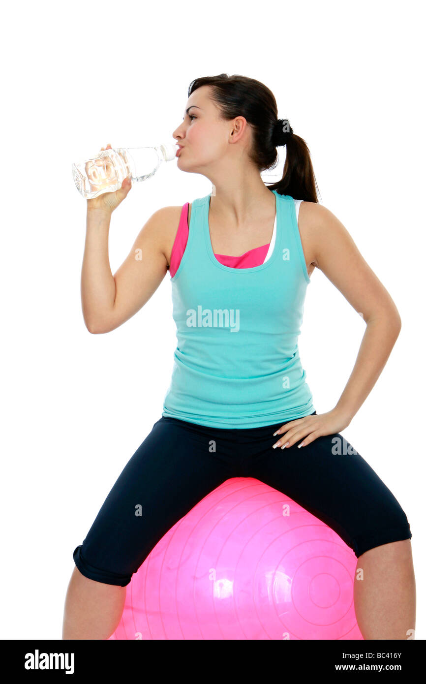sportliche Frau macht Pause auf einem Gymnastikball sporty woman makes break on a exercise ball Stock Photo
