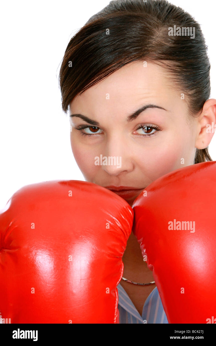 Geschäftsfrau boxt sich durch business woman fighting with sports boxing gloves Stock Photo