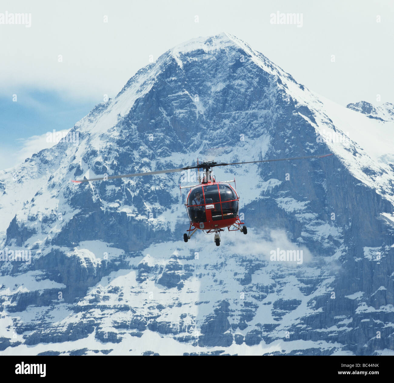 rescue helicopter in front of the Eiger mountain near Interlaken Switzerland Stock Photo