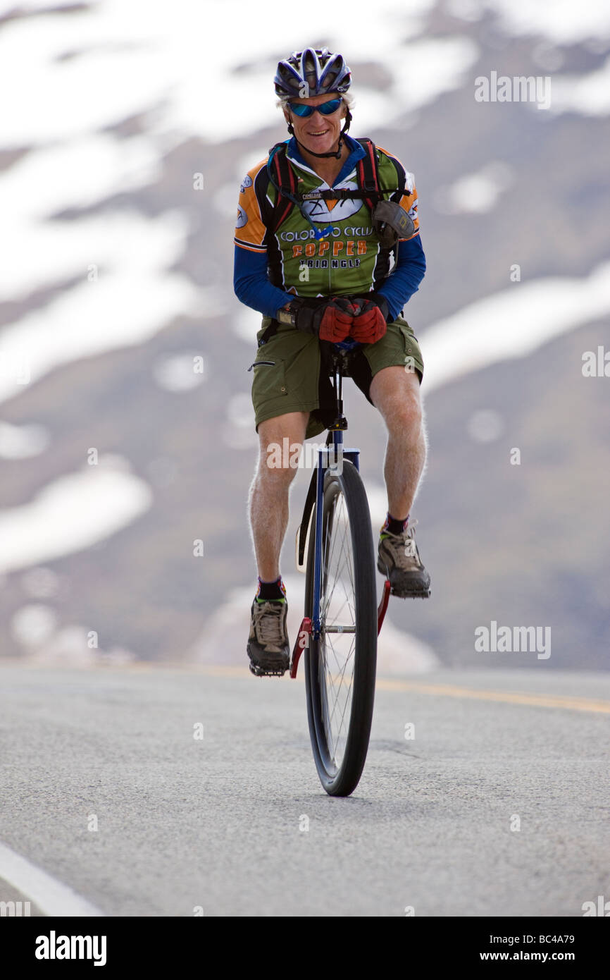 Cyclist on a unicycle riding down from Independence Pass in Colorado during the annual Ride The Rockies bicycle tour Stock Photo