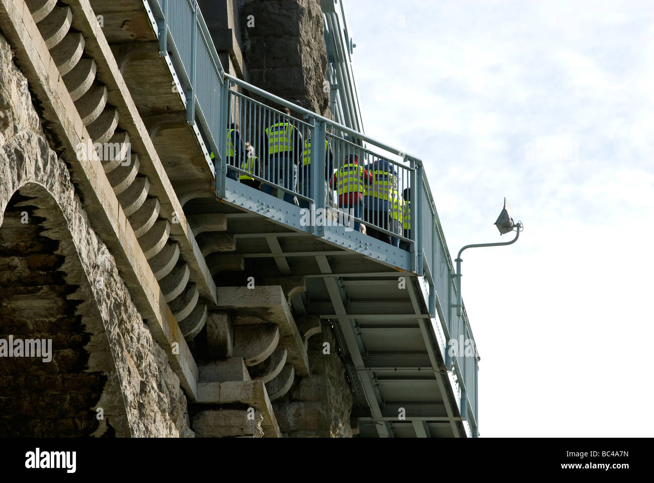 People on viewing balcony of Menai Bridge Anglesey North Wales Stock Photo