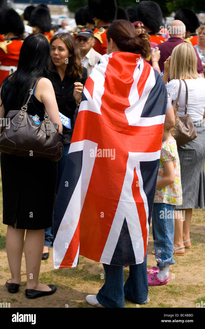 A woman wrapped in the British Union Flag on armed forces day in London. Stock Photo