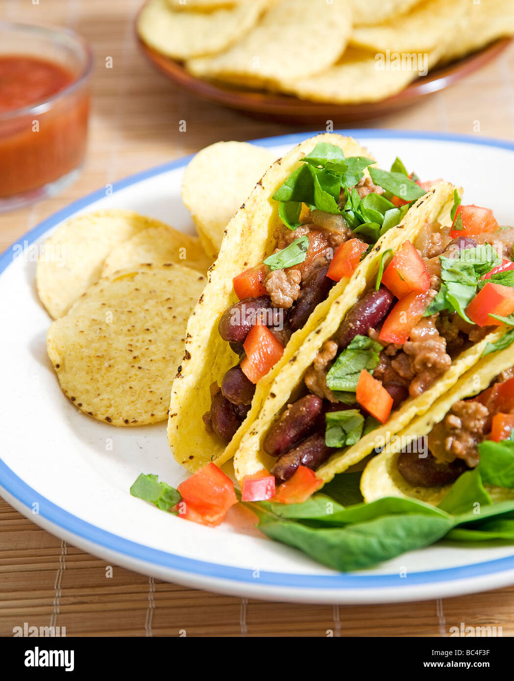 Tacos stuffed with beans meat salad and tomatoes Stock Photo