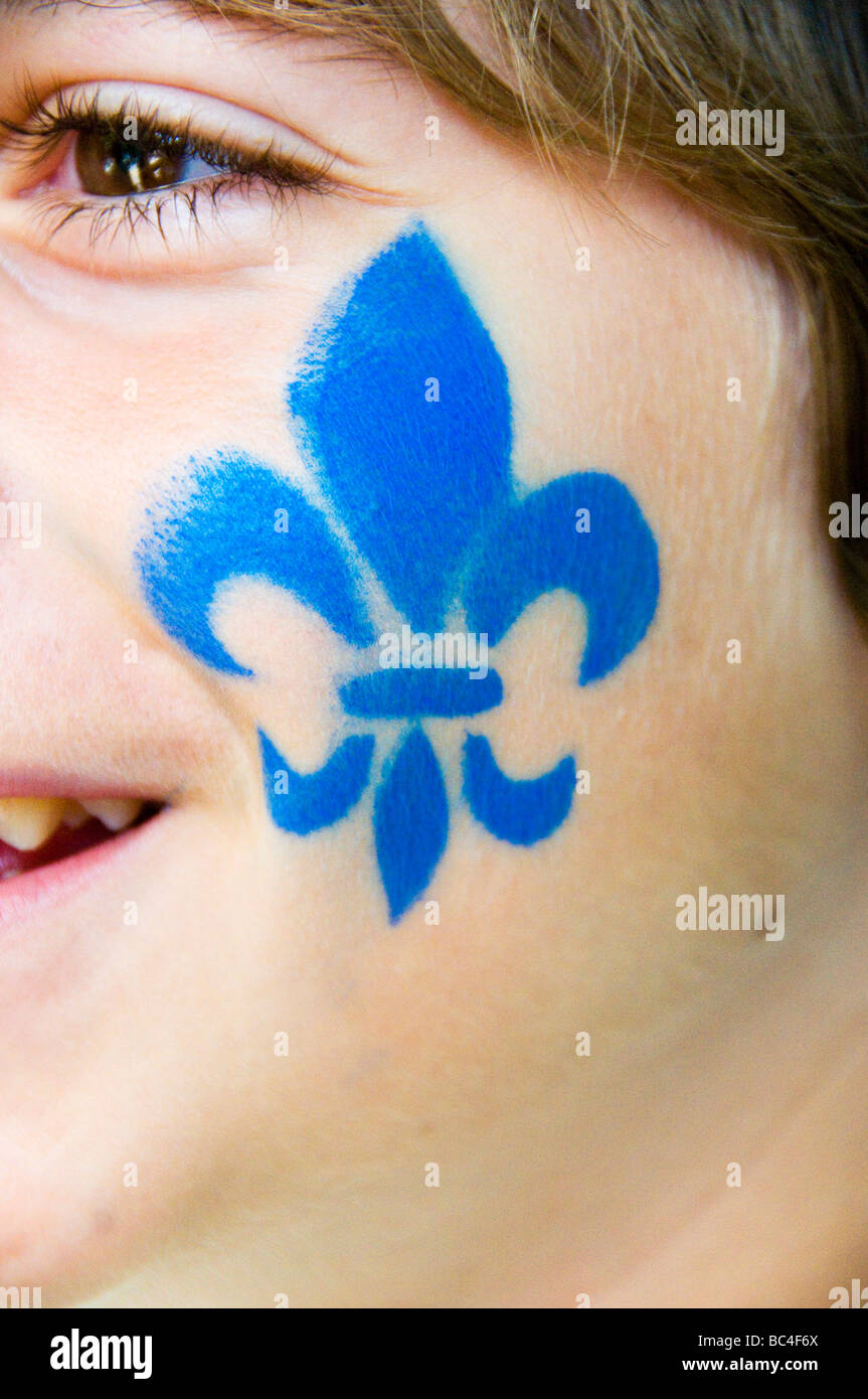 Fleur de lys symbol of Quebec painted on the face of a child St Jean Baptiste day Montreal Stock Photo
