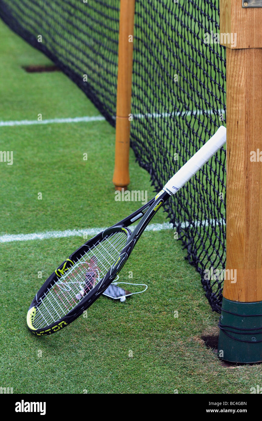 tennis racket on grass court and a net Stock Photo Alamy