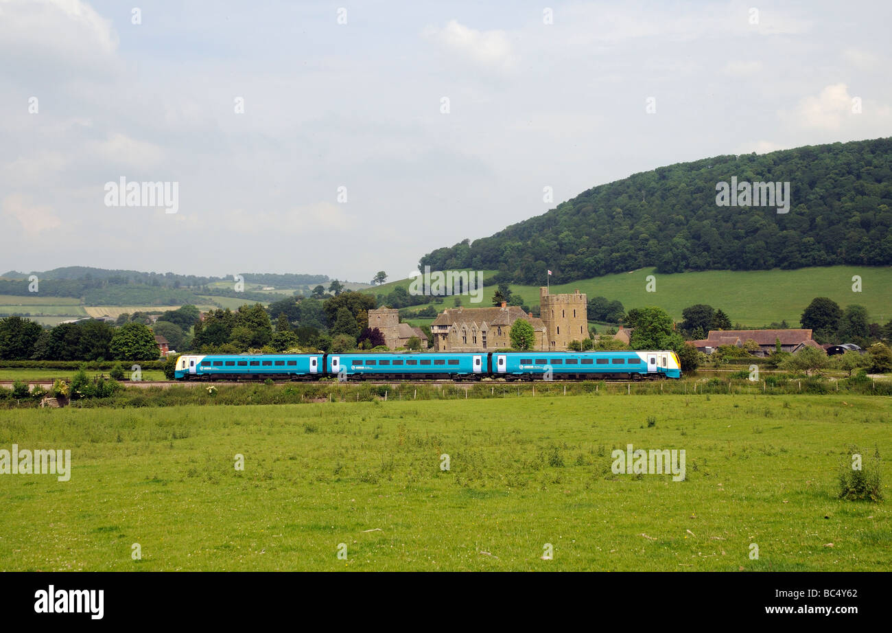 Stokesay Castle and John the Baptist Church Shropshire England UK and a Arriva passenger train passing by Stock Photo