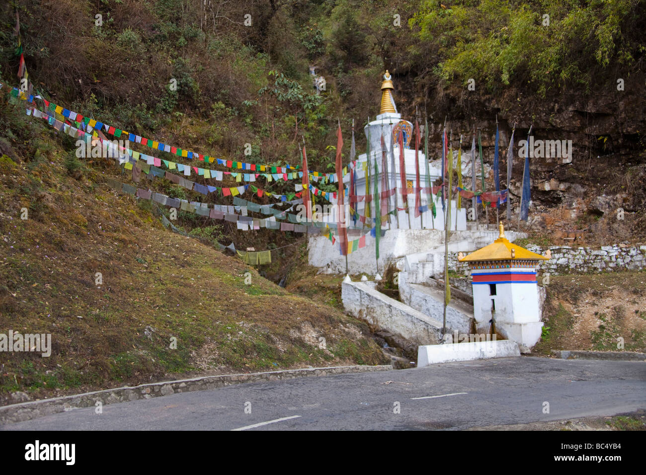 Stuppa monument and prayer flags near road in Bhutan Asia  Horizontal  91509 Bhutan Stock Photo