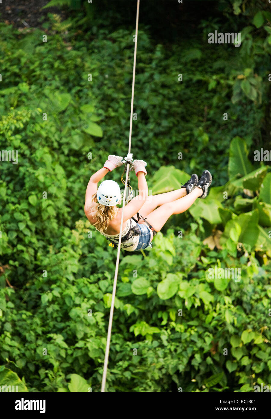 A tourist zips across the route of Skytrek Zip Line Tours in La Fortuna