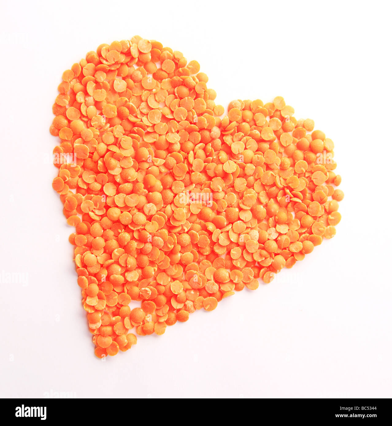 Orange Split Lentils in Heart Shape Stock Photo