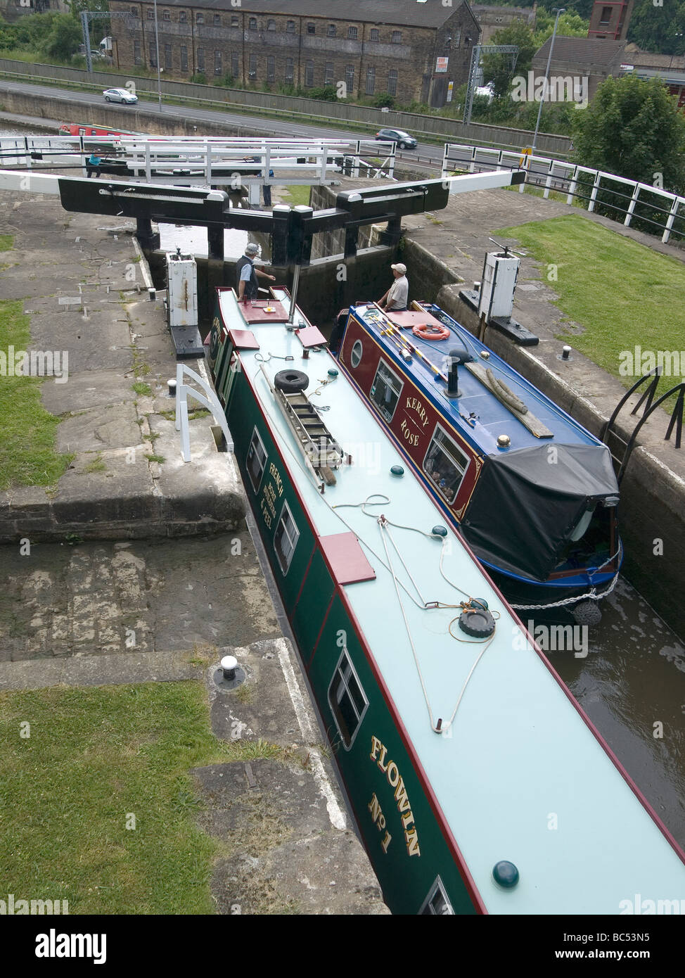 Two narrow boats ascending the 3 rise locks at Bingley West Yorkshire on the Leeds and Liverpool canal Stock Photo