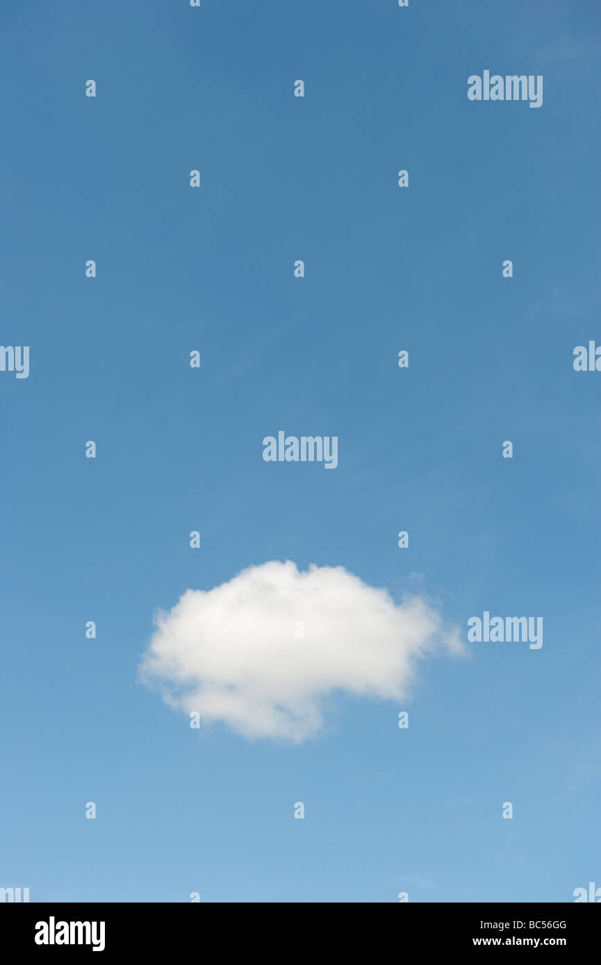 single fluffy white cloud floating alone  in a blue sky Stock Photo