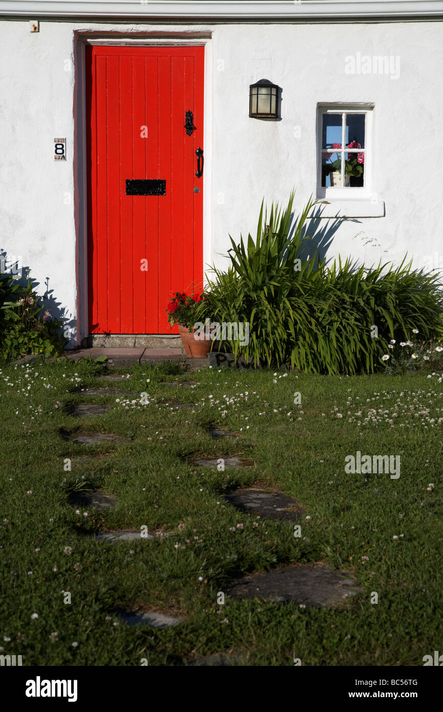 red painted door and footpath leading to cottage in former fishing