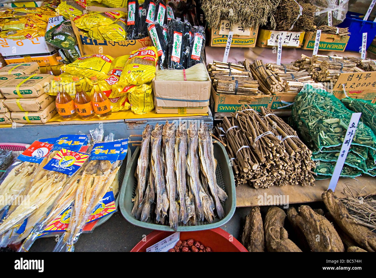 Dried seafood, spices, vegetables, and packaged goods on display at