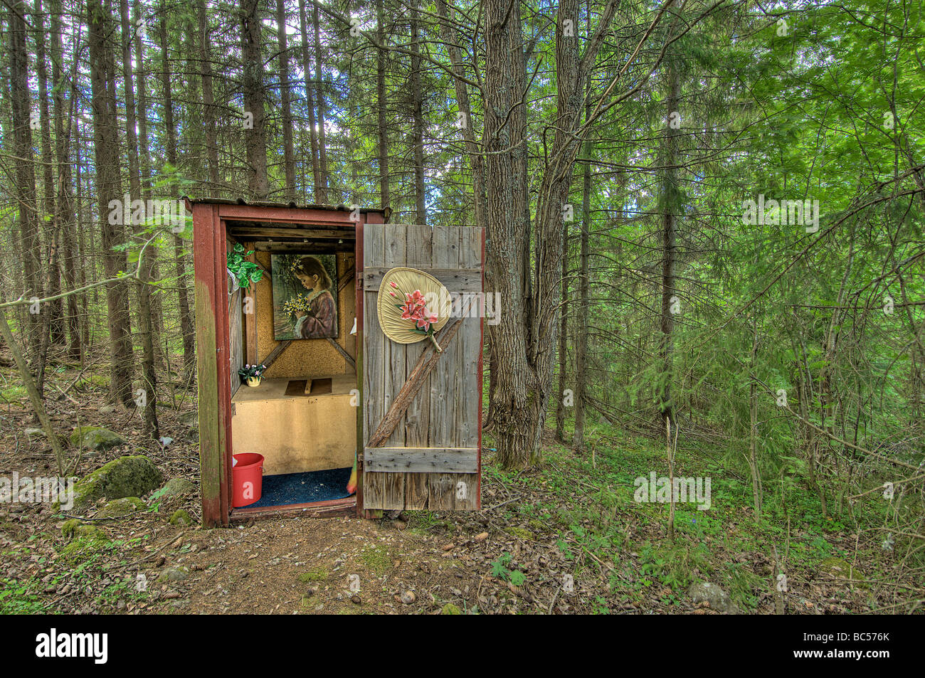 An example of a decorated outhouse waits in the woods of Fallesvikshamn nea Nordingra on the Baltic coast  Stock Photo