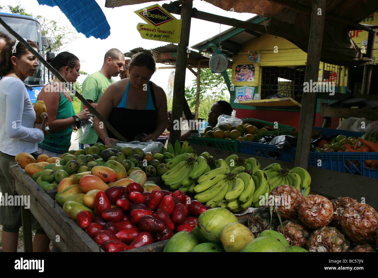 Tourists buying tropical fruits from a side road fruit stall in Middle Quarters, Jamaica Stock Photo