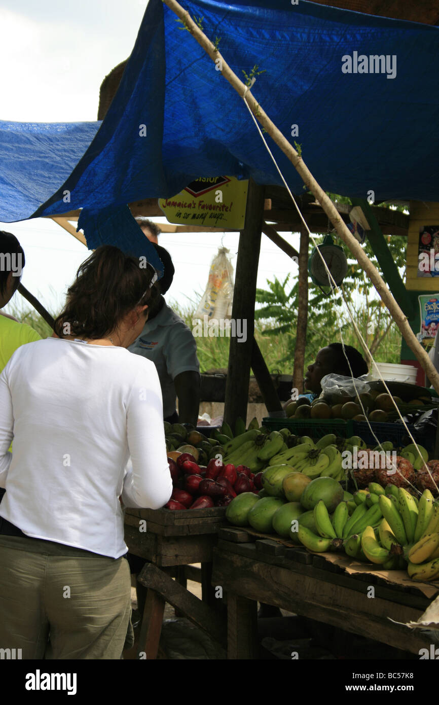 Tourists buying fruits from a stall in Middle Quarters, Jamaica Stock