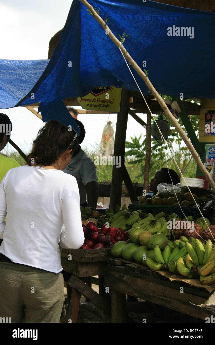 Tourists buying fruits from a stall in Middle Quarters, Jamaica Stock Photo