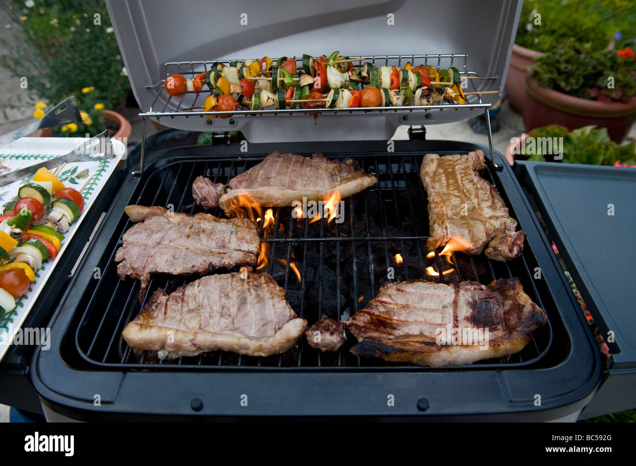 Sirloin Steaks Cooking On A Barbecue Stock Photo Alamy