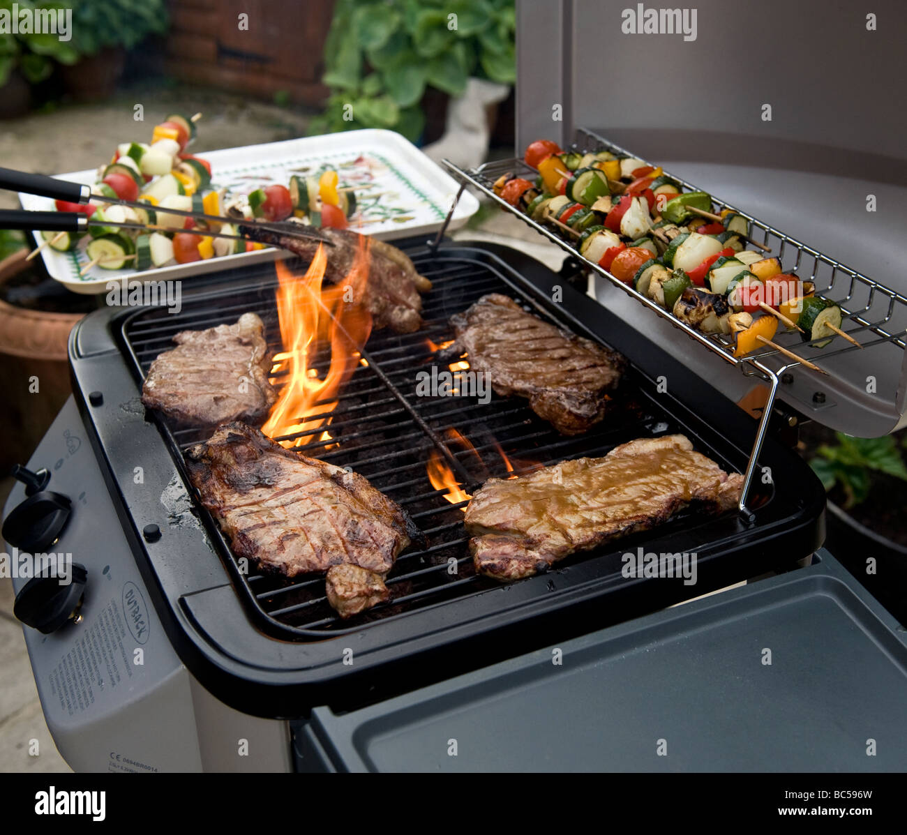 Sirloin Steaks Cooking On A Barbecue Stock Photo Alamy