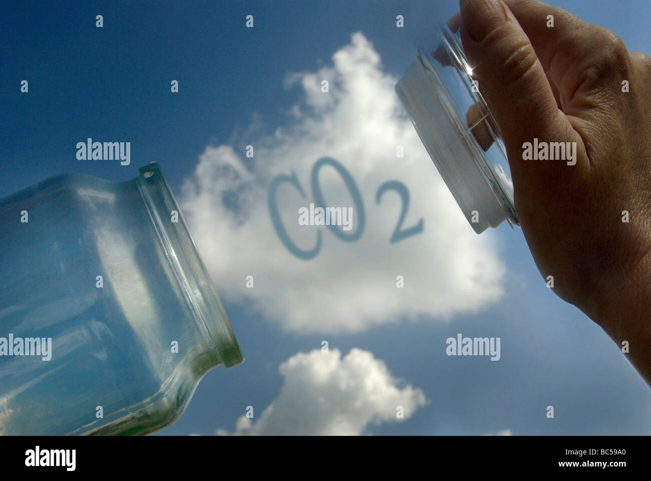 Carbon capture and storage concept with cloud being trapped inside a jar with CO2 graphic . Stock Photo