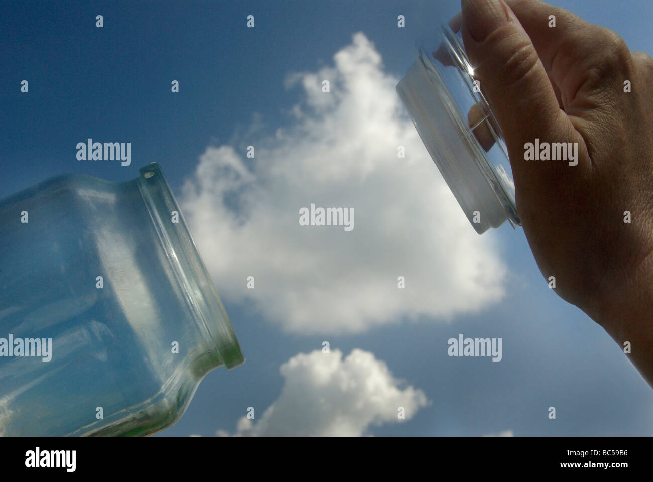 Carbon capture concept depicing a cloud (CO2) being trapped into a jar (storage) Stock Photo