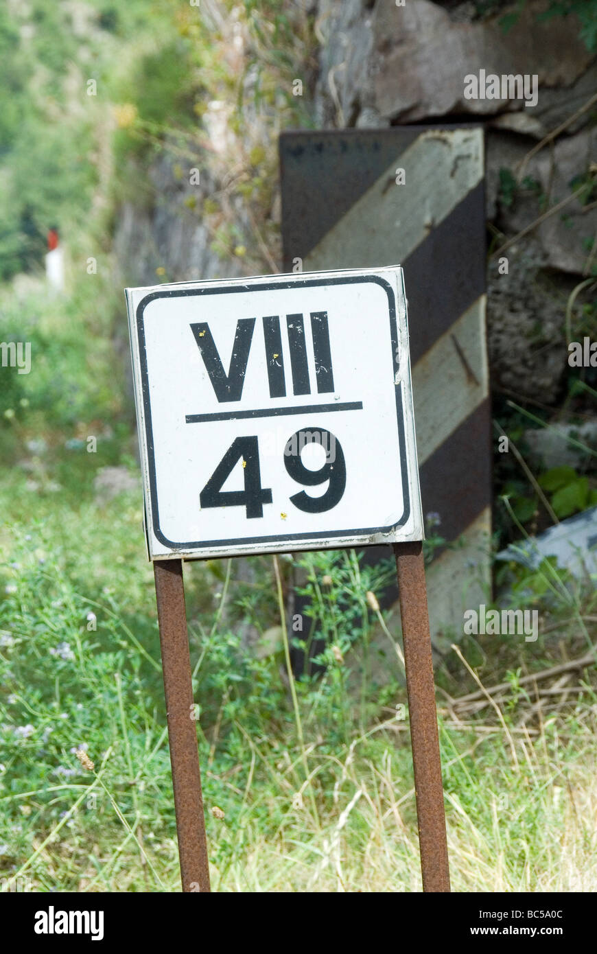 Road milage sign in Roman and Normal numberals Stock Photo