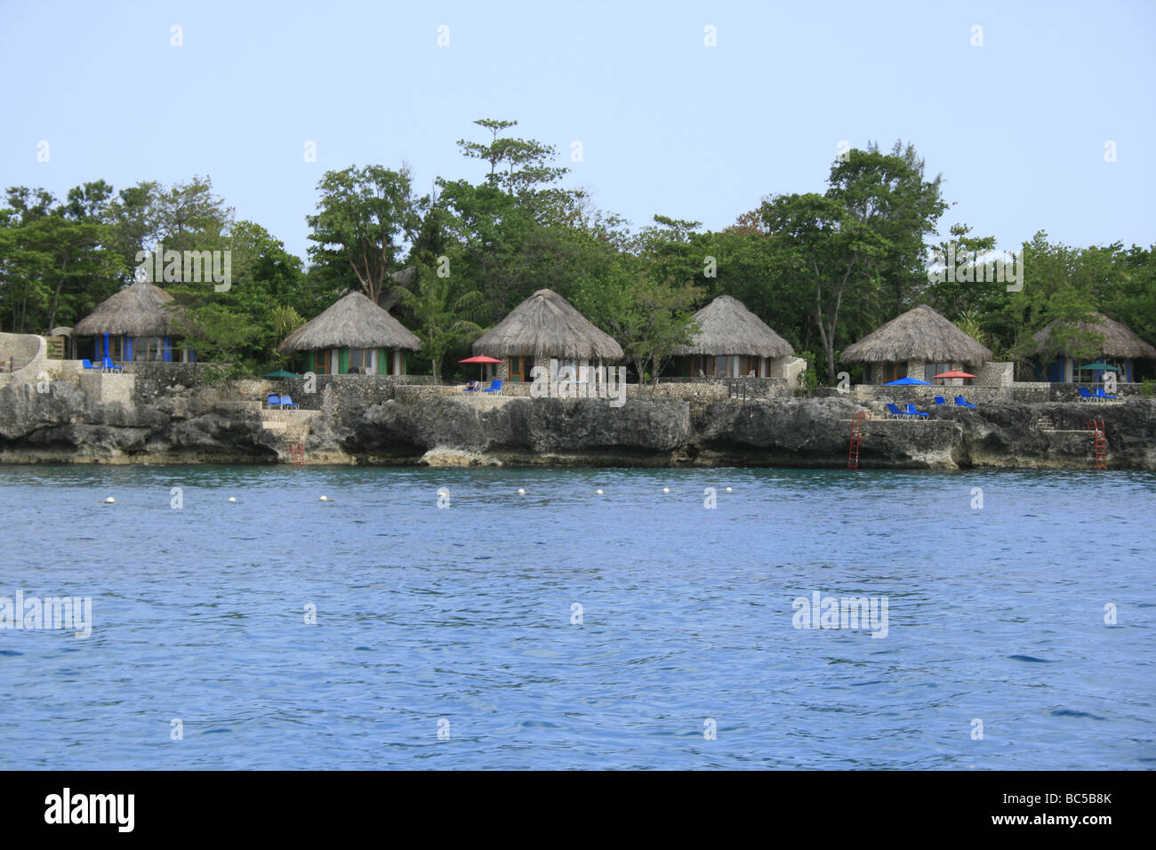 Hotel with traditional Jamaican thatched huts on the Negril coast Stock