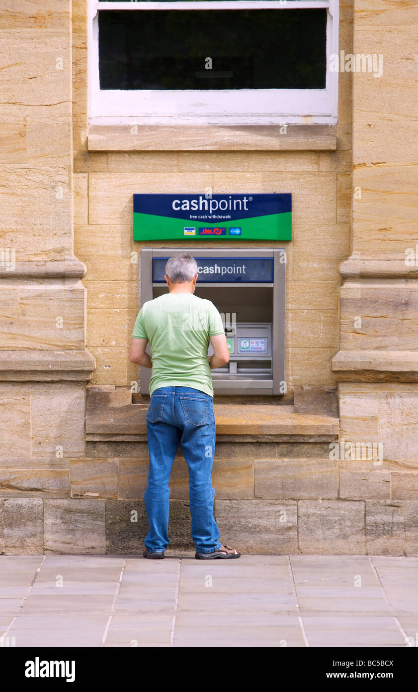 Person using cash dispenser Stock Photo Alamy