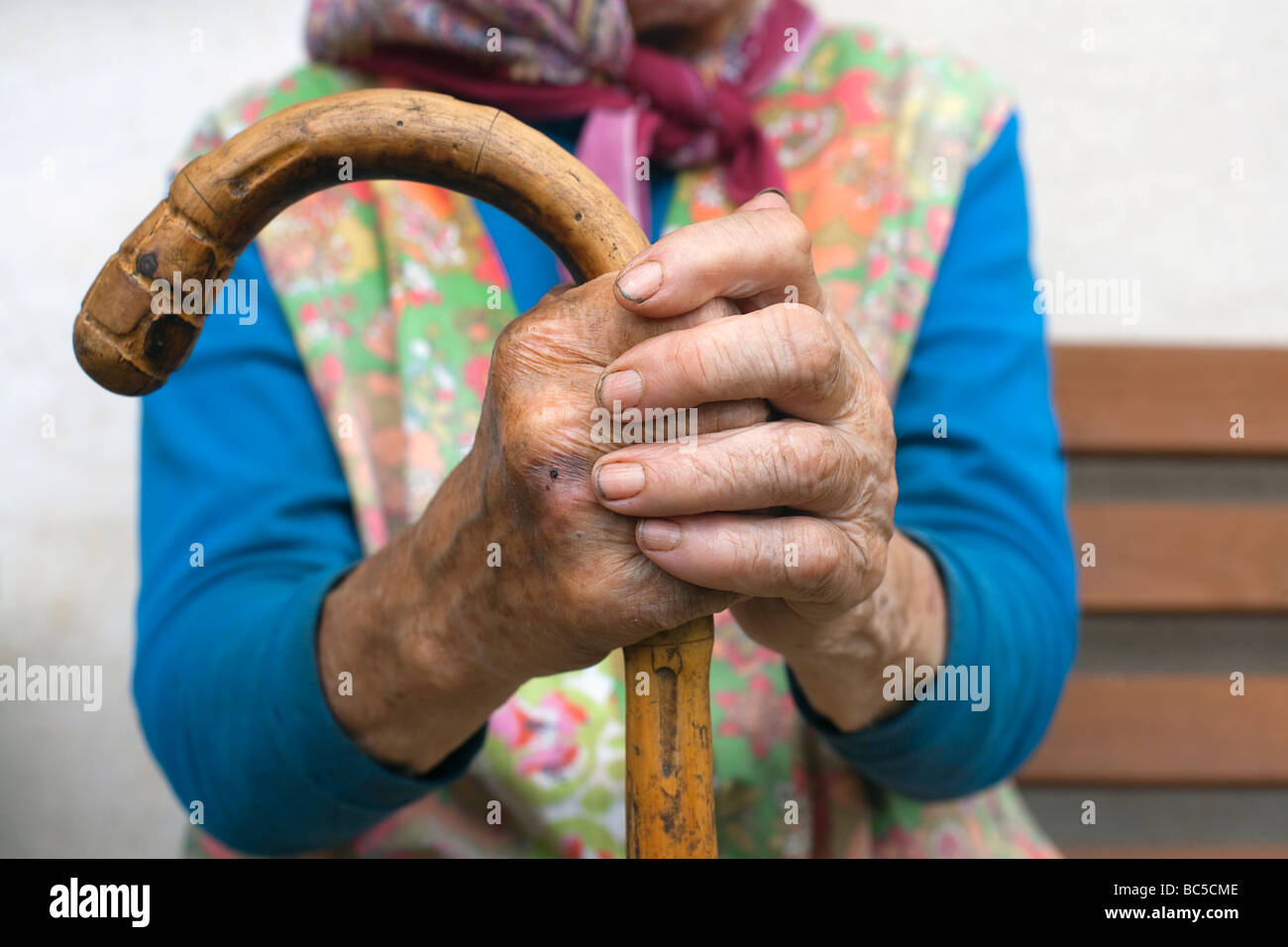 hand of an old peasant woman holding a walking stick Stock Photo