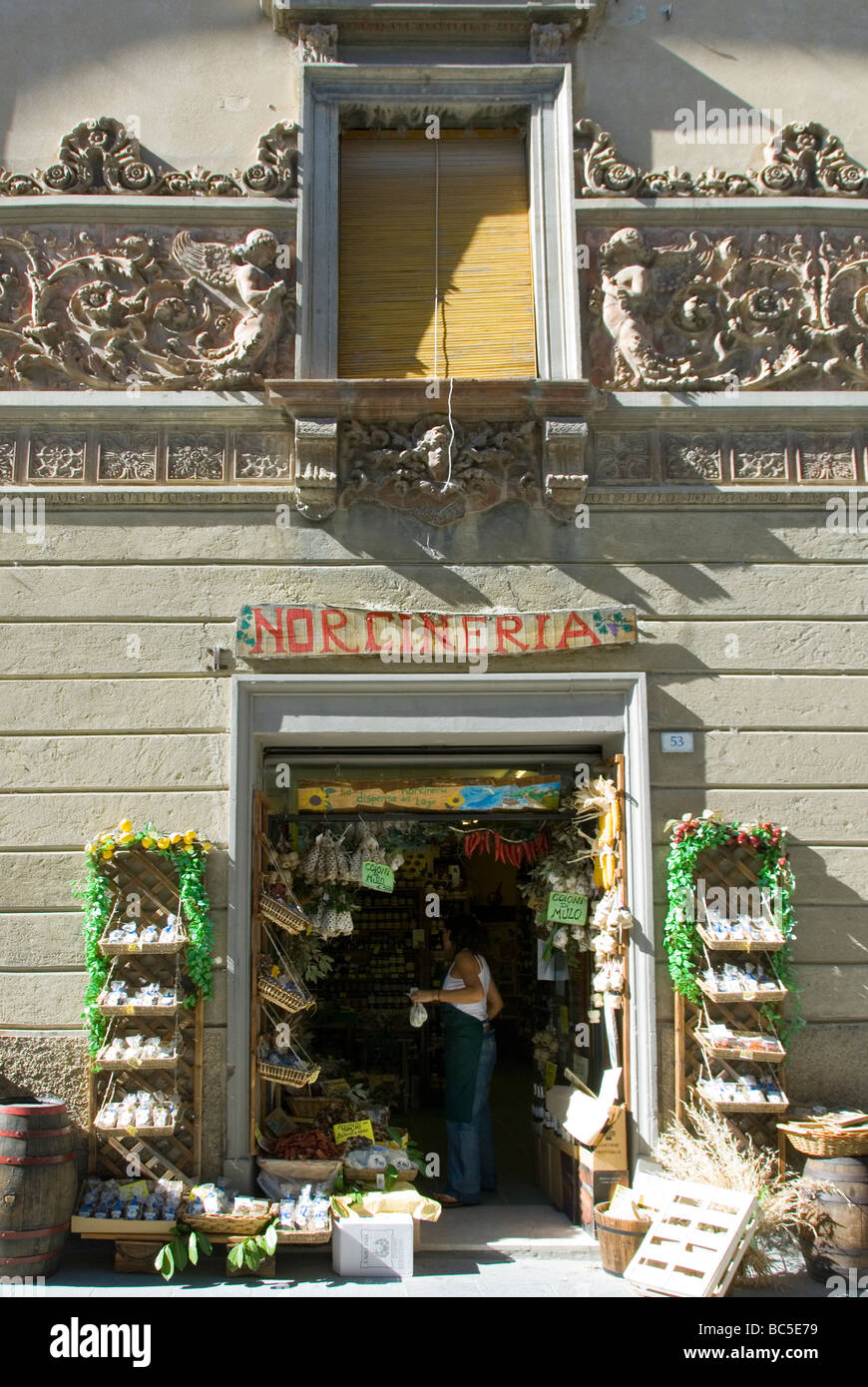 Norceria or specialty food shop in Castiglione del Lago with a Liberty style frieze in terracotta on the facade of the palazzo Stock Photo