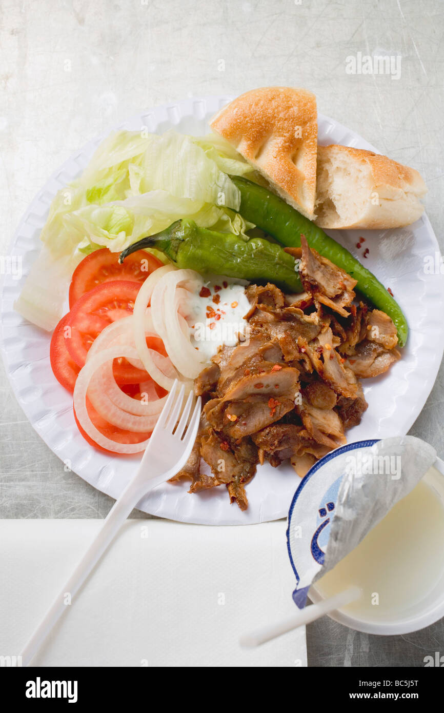 Döner kebab with vegetables on paper plate, drinking yoghurt Stock ...