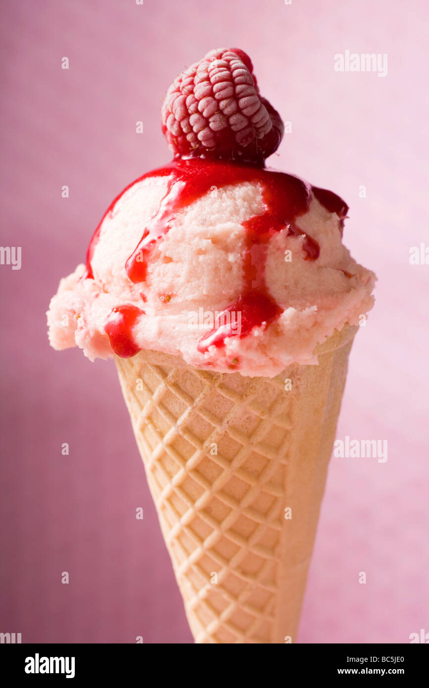 Ice cream with raspberry and raspberry sauce in wafer cone Stock Photo ...