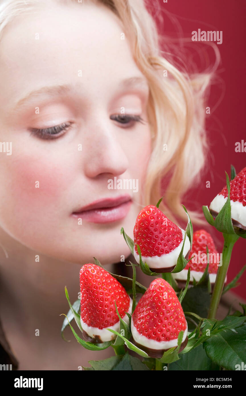 Young woman with bouquet of chocolate-dipped strawberries - Stock Photo
