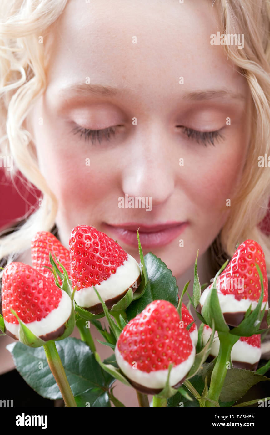 Young woman with bouquet of chocolate-dipped strawberries - Stock Photo