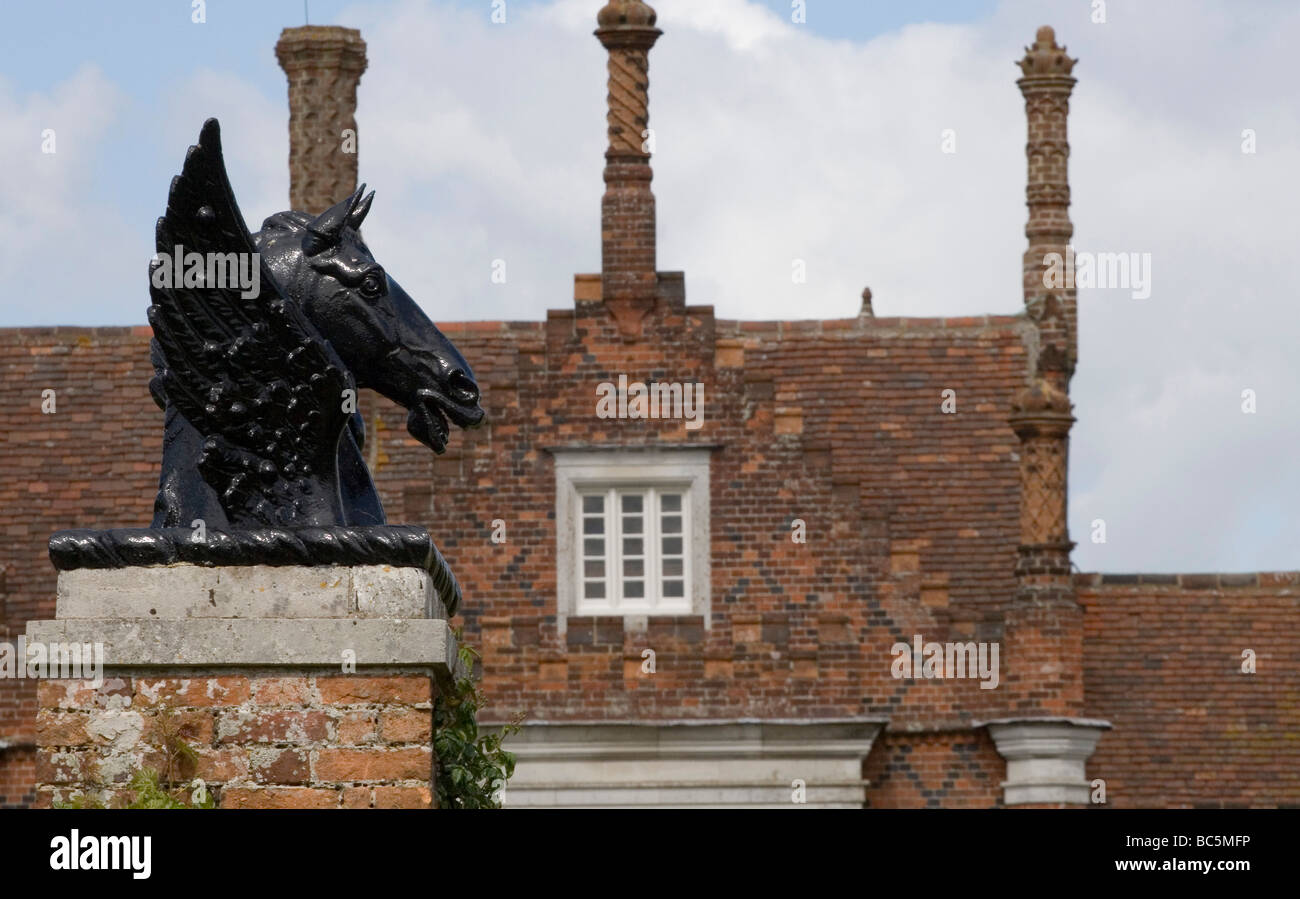 Black cast head of a winged horse against the Tudor Helmingham Hall in Suffolk Stock Photo