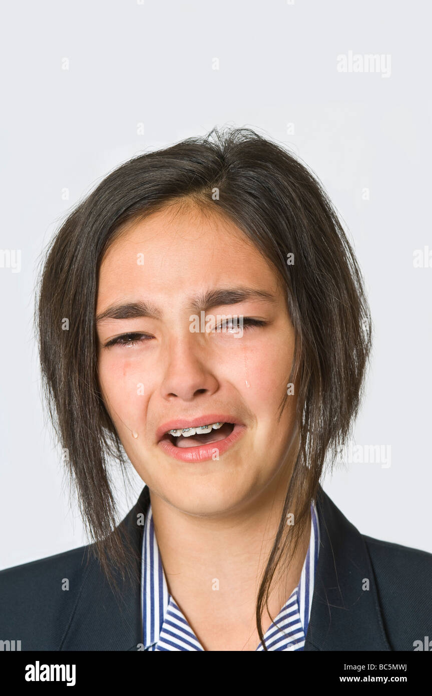 Head and shoulder portarait of a young caucasian girl (12) crying ...