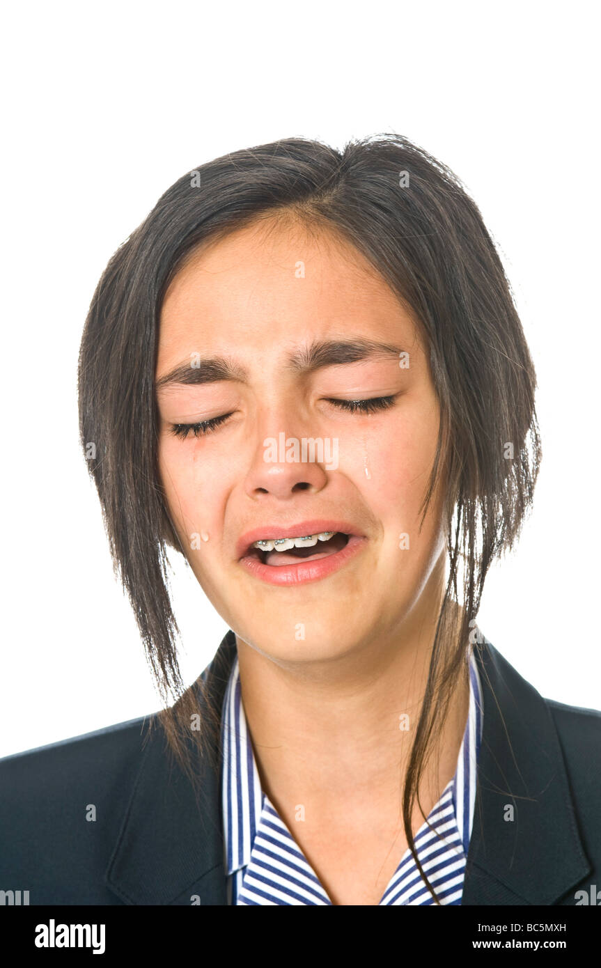 Head and shoulder portarait of a young caucasian girl (12) crying