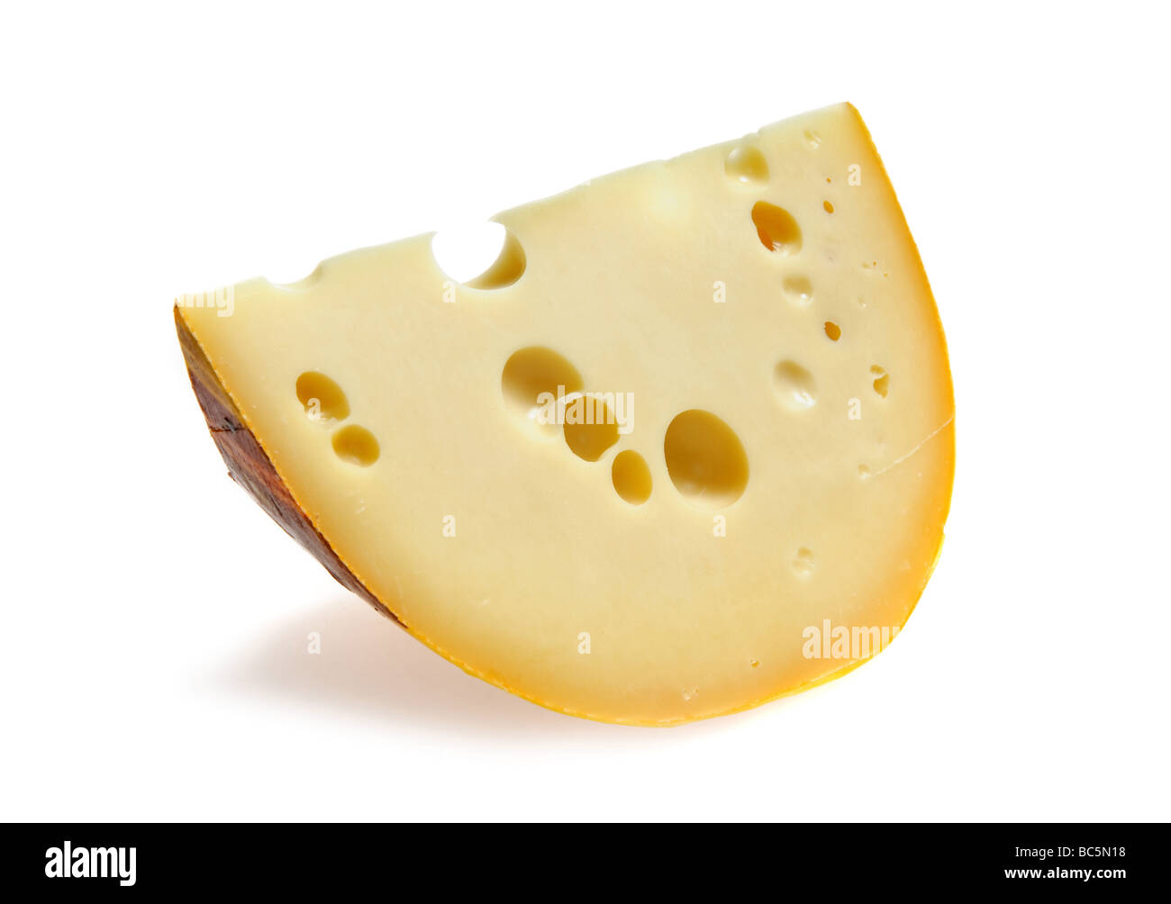 Piece of cheese with holes Stock Photo