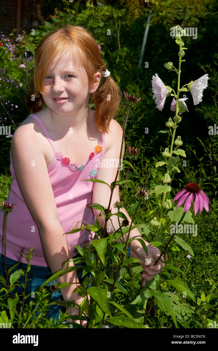 Girl is plucking flowers in the garden Stock Photo Alamy