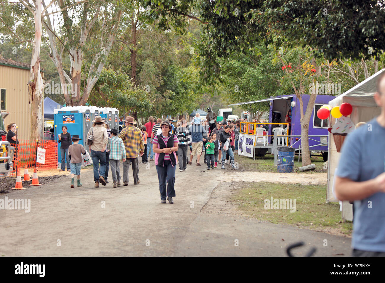 Crowd of people touring the stands and displays at a local agricultural