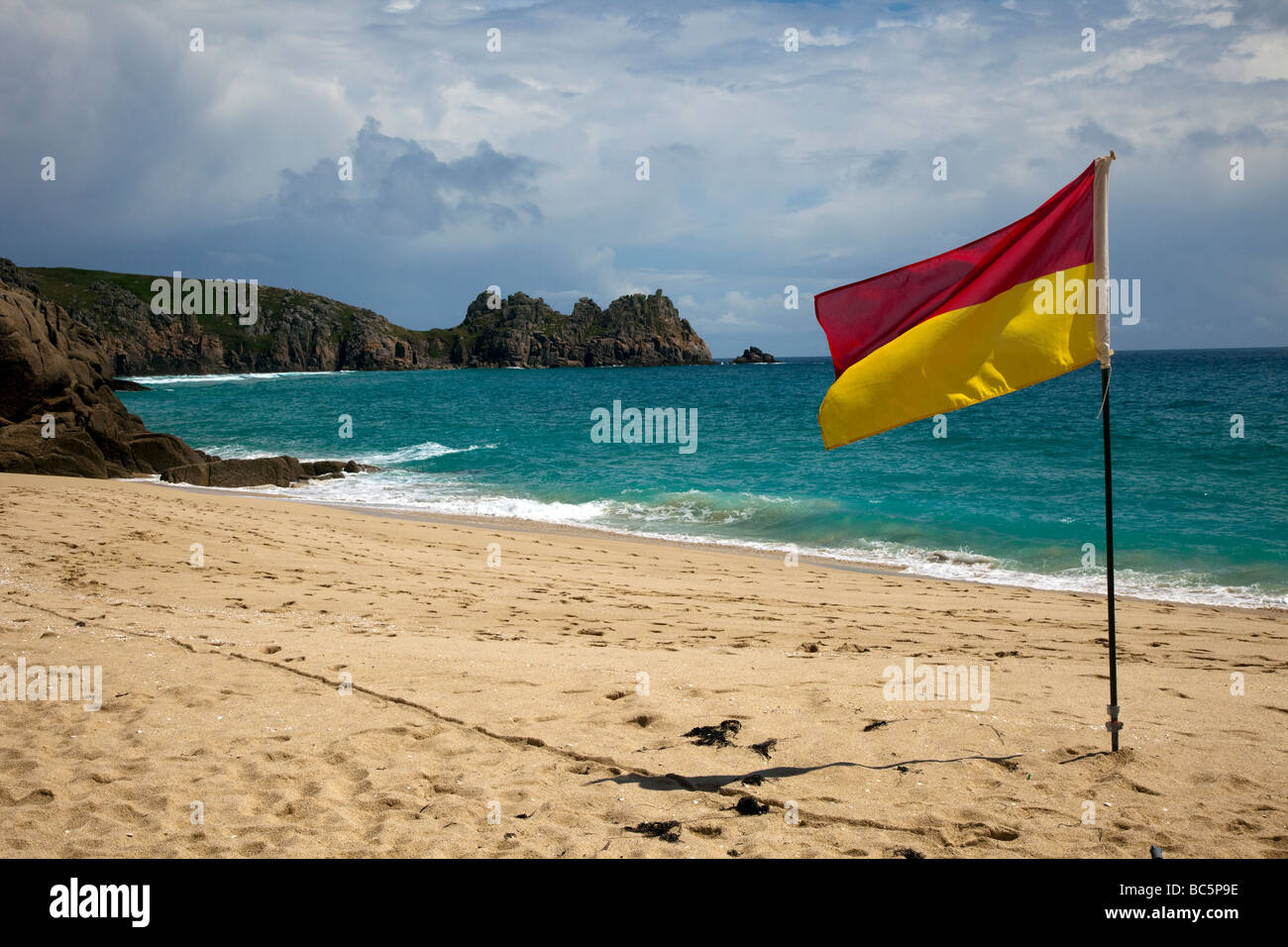 Beach Safety Flags RNLI Lifeguarded beach Porthcurno, Cornwall, UK