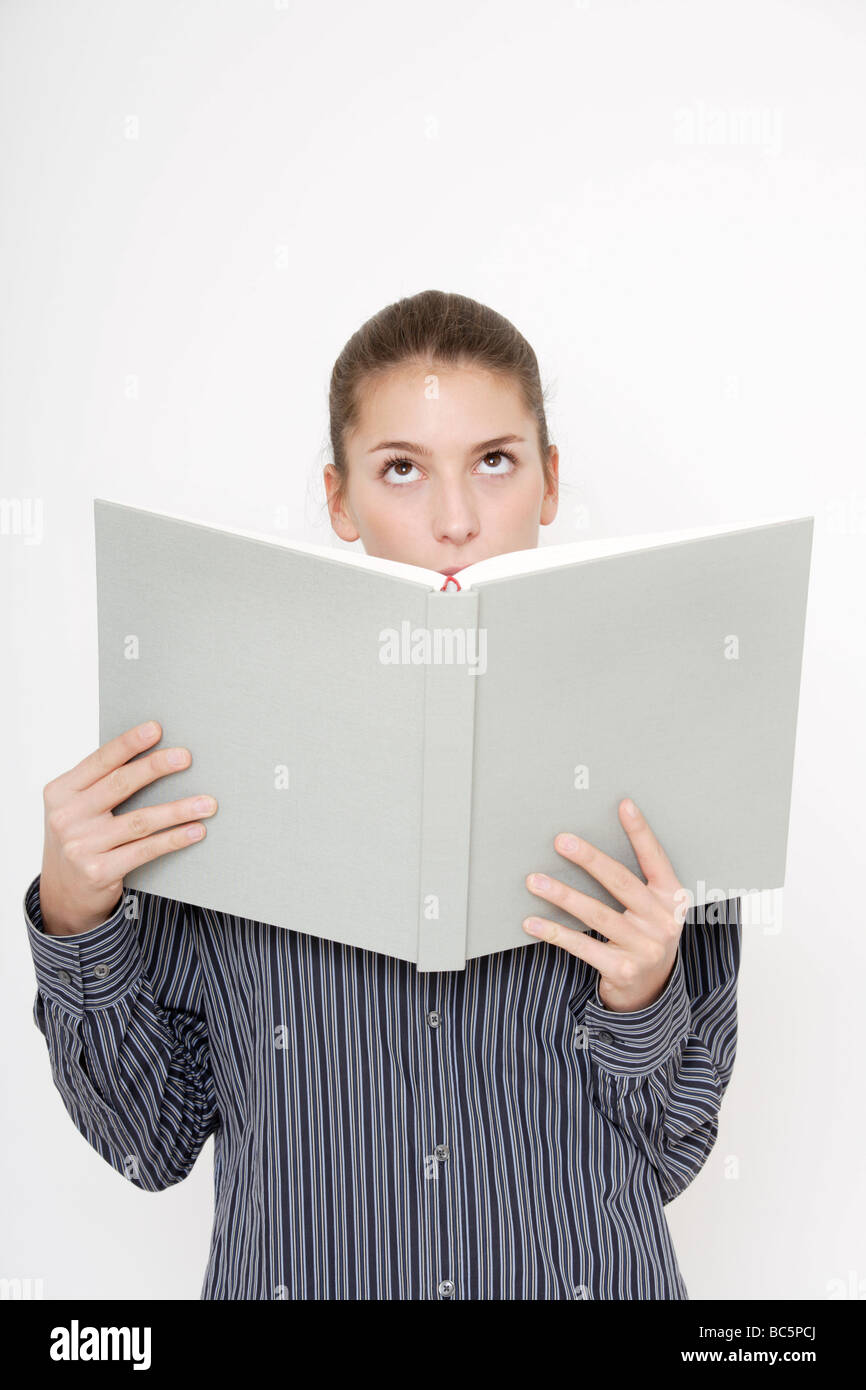 Young woman (16-17) reading documents Stock Photo