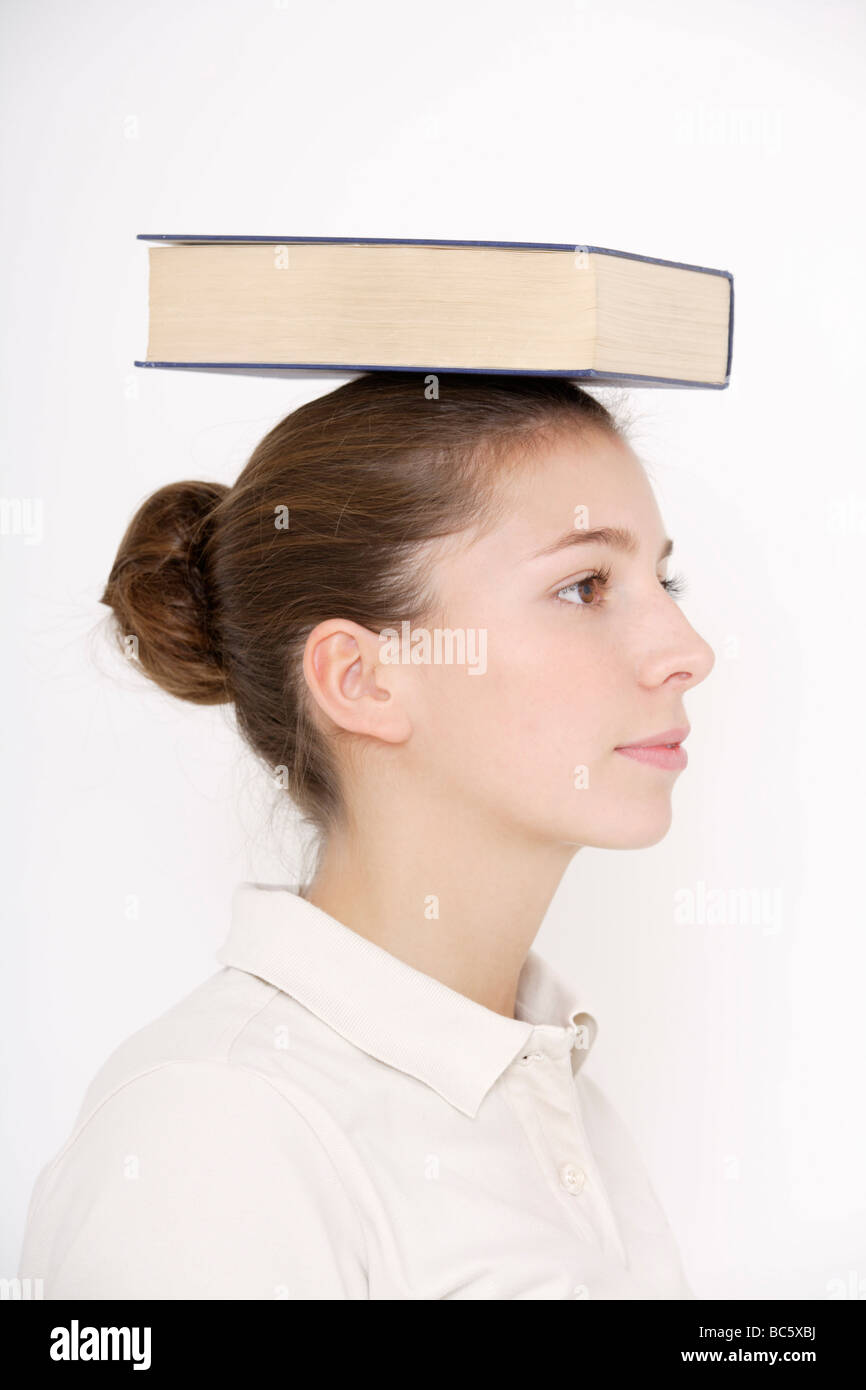 Young woman (1617) balancing book on head Stock Photo Alamy