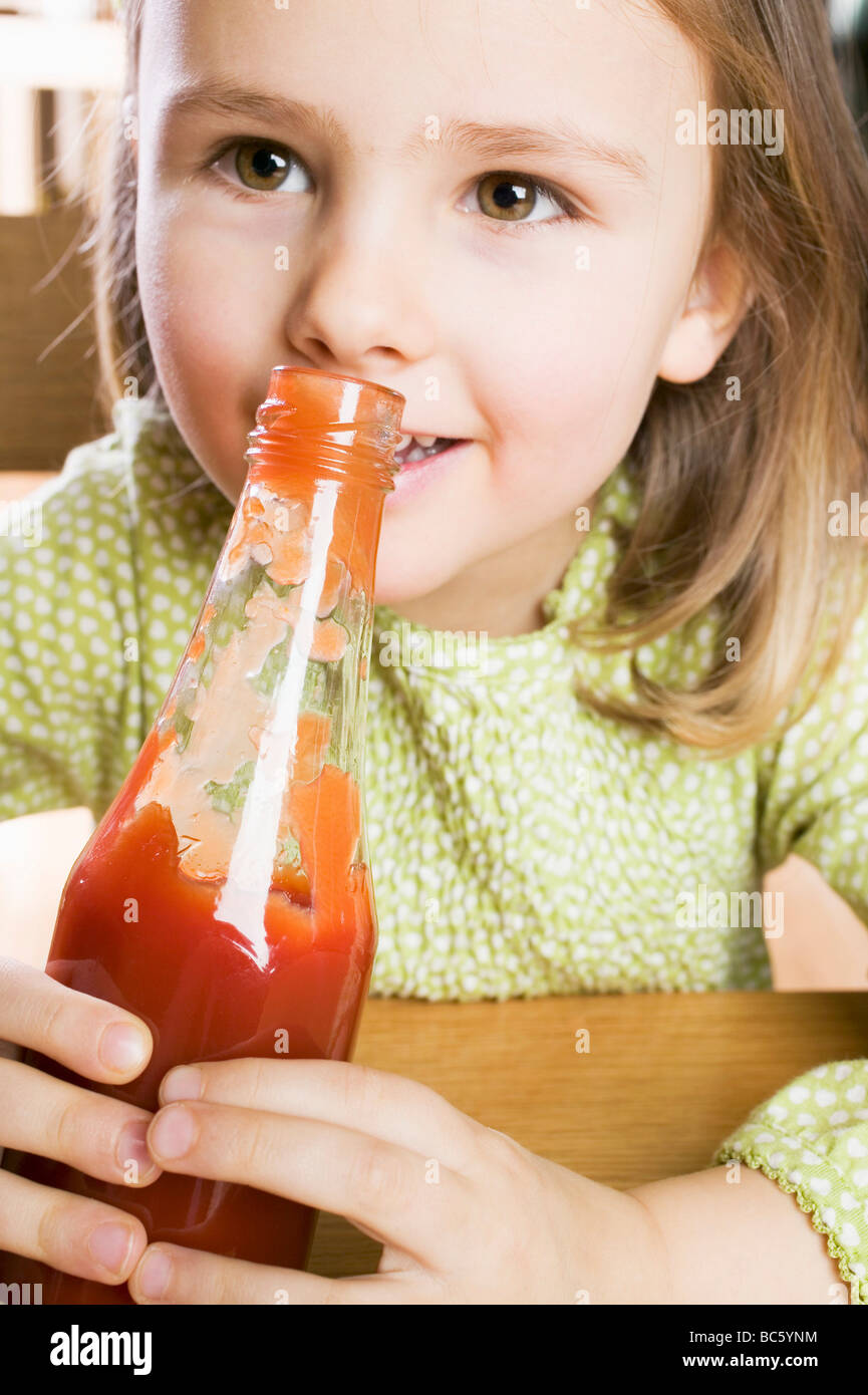 Girl holding a bottle of ketchup Stock Photo Alamy