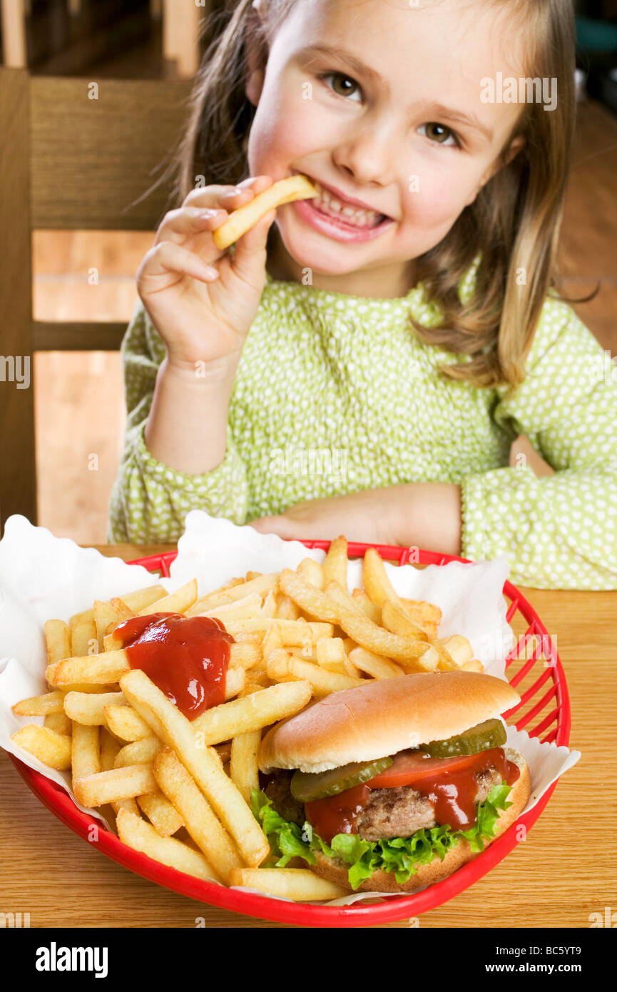 Girl Eating Chips With Ketchup And Hamburger Stock Photo Alamy girl-eating-chips-with-ketchup-and-hamburger-stock-photo-alamy