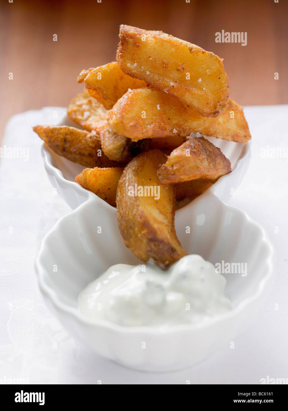 Potato wedges with yoghurt dip Stock Photo Alamy